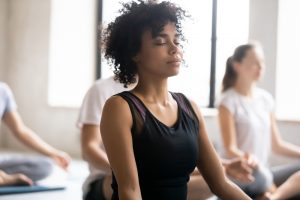 woman doing yoga to help with adrenal fatigue